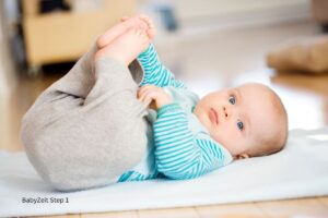 Liegendes Baby mit angezogenen Beinen